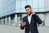 a person wearing a suit and tie talking on a cell phone